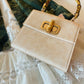 Cream Satchel with Gold Chain Handle and Structured Design